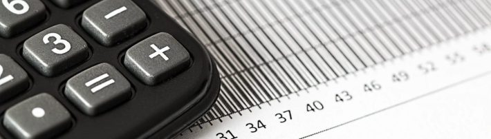 calculator and pen on table